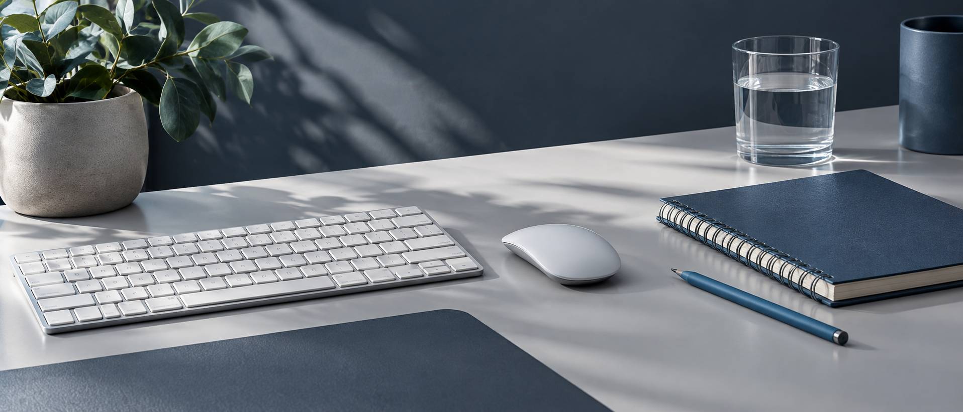 Clavier, souris et carnet ferme sur un coin de bureau